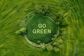 Schilderijen op glas Aerial view of a green field landscape with Go Green text © grey