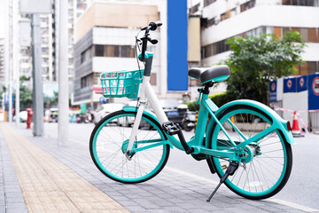 Fototapeta na wymiar Beautiful pastel green bicycle parked on city street