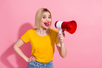 Photo of carefree funky lady dressed yellow t-shirt shouting bullhorn empty space isolated pink color background
