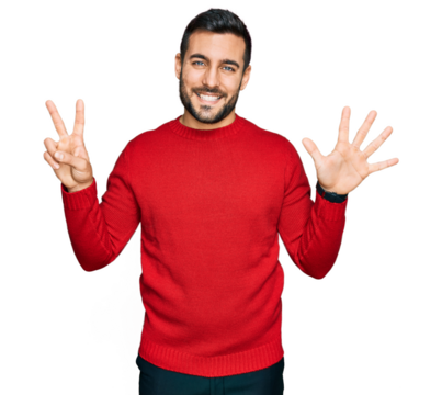 Young hispanic man wearing casual clothes showing and pointing up with fingers number seven while smiling confident and happy.
