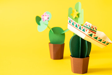 Cinco de Mayo concept - paper craft cactus on solid color background