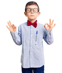 Cute blond kid wearing nerd bow tie and glasses relax and smiling with eyes closed doing meditation gesture with fingers. yoga concept.