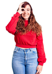 Young beautiful woman wearing casual winter sweater doing ok gesture with hand smiling, eye looking through fingers with happy face.