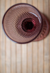 Pink wine glass on table top view