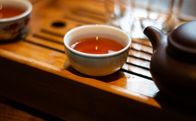A porcelain bowl and clay teapot for a tea ceremony on a tea board