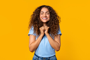 Young woman with clenched hands in delight