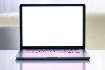Laptop with a blank white screen on a blurred light background.