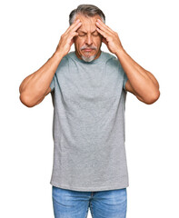 Middle age grey-haired man wearing casual clothes suffering from headache desperate and stressed...