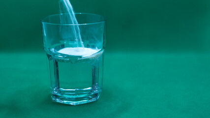 glass with water and medicine powders