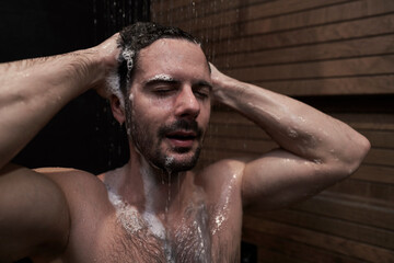 Caucasian man taking shower at home - 774909163