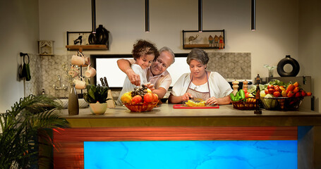 Indian Asian happy old family girl kid cute child eat healthy grapes fruit modern kitchen enjoy day fun joy senior male female lover couple pair smiling cut fresh diet food cook indoor home house	