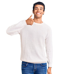 Fototapeta premium Young african amercian man wearing casual clothes doing happy thumbs up gesture with hand. approving expression looking at the camera showing success.