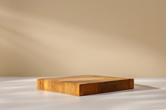 Square wooden podium for display product on baige wall