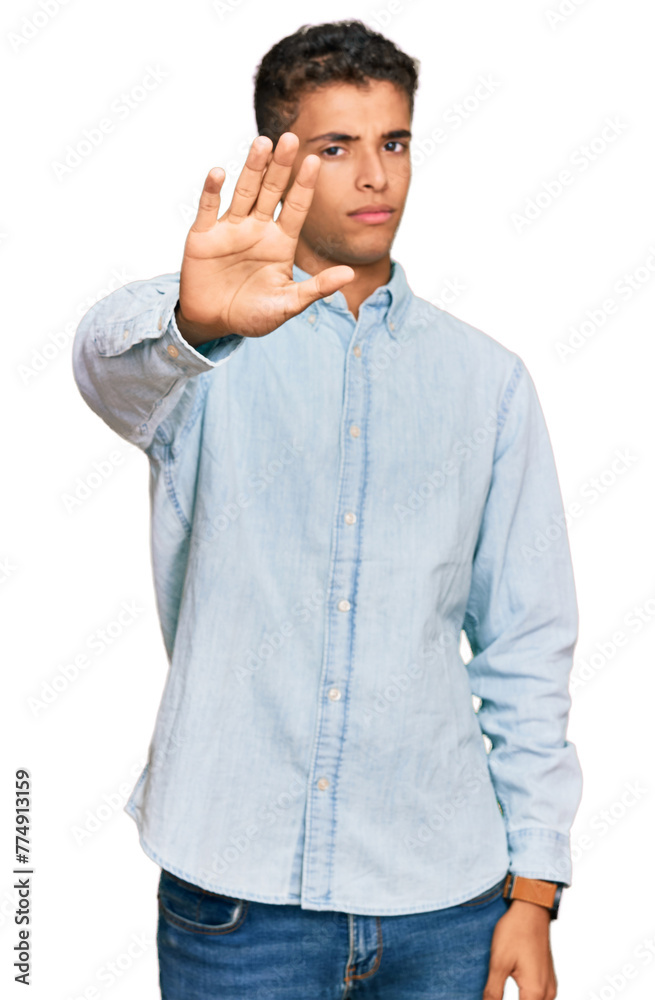 Sticker young handsome african american man wearing casual clothes doing stop sing with palm of the hand. wa