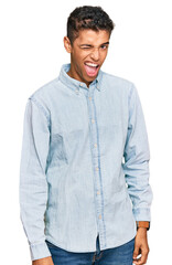 Fototapeta premium Young handsome african american man wearing casual clothes winking looking at the camera with sexy expression, cheerful and happy face.