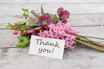 greeting card with Bouquet of pink hyacinths, Christmas roses and card with English text: Thank you