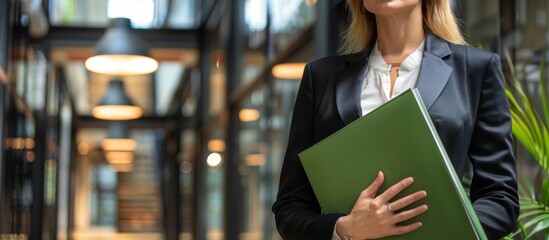 Businesswoman holding a green folder