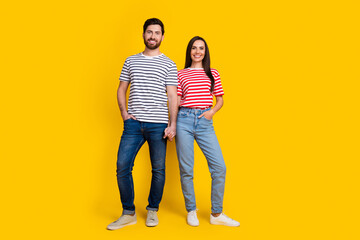 Full size photo of two people girl guy dressed striped t-shirt hold hands together arms in pockets...
