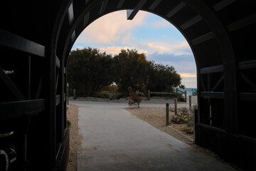 Entrance to historic whaling tunnel in Fremantle, forming a frame for the onset of sunset colors in...