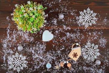 Obraz na płótnie Canvas New Year's card on a wooden background.Christmas balls are toys.the glove of Santa Claus.santa claus.Snowflake.Birdie.A branch of the Christmas tree.festive background, place for text.bathhouse 