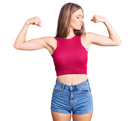 Young beautiful blonde woman wearing elegant summer shirt showing arms muscles smiling proud. fitness concept.