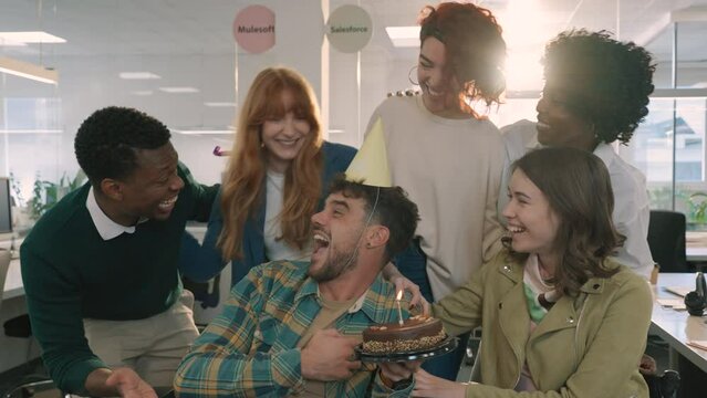 A multiracial businesswoman having birthday celebration at the office.