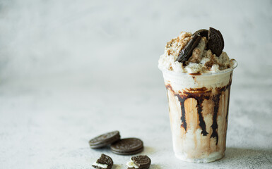 Chocolate milk shakes with cinnamon, chocolate pieces and various spices on stone background.