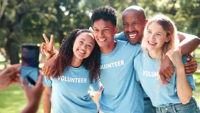 Friends, smartphone and happy volunteer, people or charity workers in nature together for social media. Nonprofit, collaboration or diversity community volunteering, picture with teamwork or help