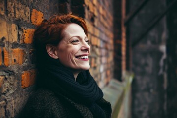 Portrait of smiling middle-aged woman with red hair in scarf.