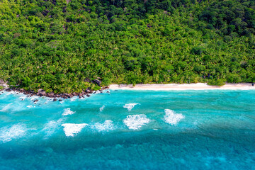 beautiful tropical beach with sea and palm trees taken from drone. Seychelles. Vacation holidays