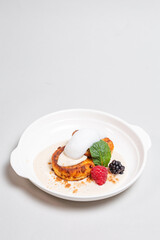 Delicious cottage cheese pancakes with raspberries and blackberries on a white background. Breakfast
