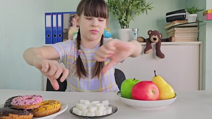 Diet or good health concept, teenage girl refuses junk food or junk food. Donuts or desserts, and chooses healthy foods, such as fresh fruits or vegetables.