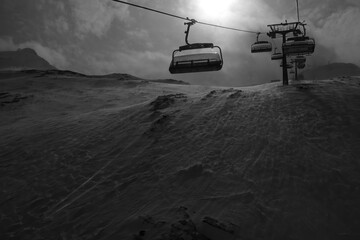 Ski Lift on a stormy day goiing up the mountain, black and white