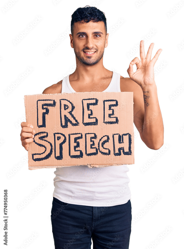 Poster Young hispanic man holding free speech banner doing ok sign with fingers, smiling friendly gesturing excellent symbol