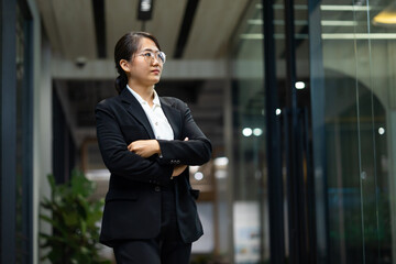 Portrait Smiling confident young business woman standing at home office. looking at camera arms crossed