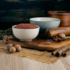 HAWAIIAN RED SALT on wooden table background. Herbs, spices and dried food baking ingredient. Mortar and different spices. Cottage kitchen. Product Photography