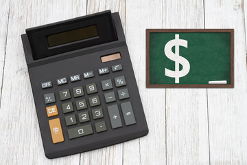  The cost of tuition for education with a black calculator with a chalkboard on wood desk - 774951394