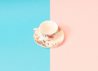 Pink and blue cups of coffee or tea isolated on blue and pink background.
