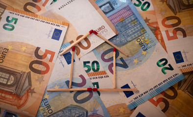 euro banknotes piled up with matchstick house.successful and prosperous