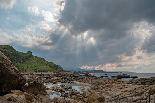 Dramatic cloud and sunlights shine on the coastline of Badouzi, in Keelung, Taiwan.