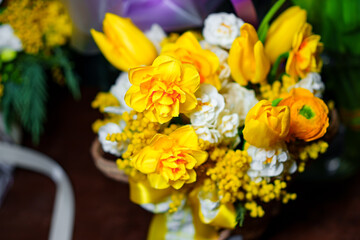 Bouquet of yellow and white tulips in a basket. Beautiful gift bouquet.