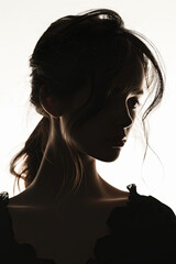 Naklejka premium A dark silhouette figure of young woman on white background, with unclear face feature