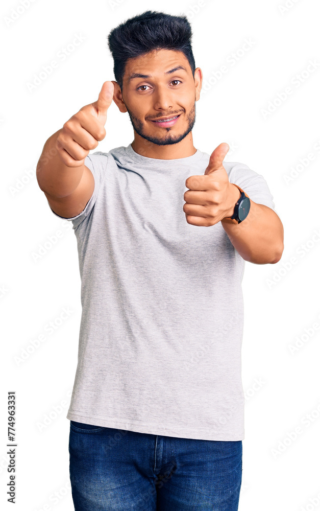 Wall mural handsome latin american young man wearing casual tshirt approving doing positive gesture with hand, 