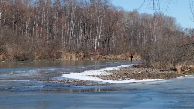 two fishermen walk along the river with a fishing rod, fishing in spring, Krasnoyarsk Territory April 2024
