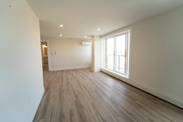 Closeup shot inside an empty living room of a house with white walls and wide windows