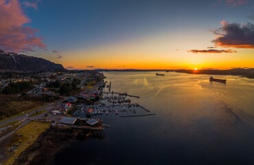 Golden sunset over the ocean and a village