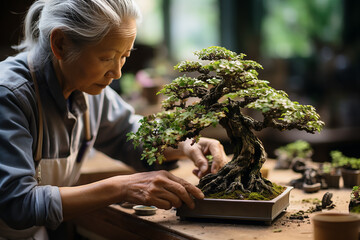 A focused elderly woman carefully pruning a bonsai tree, showcasing the art of bonsai in a tranquil setting.