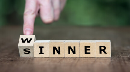 Hand turns dice and changes the word sinner to winner. Symbol for stop being a sinner and become a...
