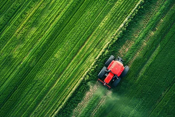 Schilderijen op glas aerial top view of modern tractor working on the summer field © Di Studio