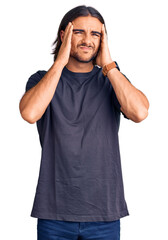 Fototapeta premium Young handsome man wearing casual clothes suffering from headache desperate and stressed because pain and migraine. hands on head.